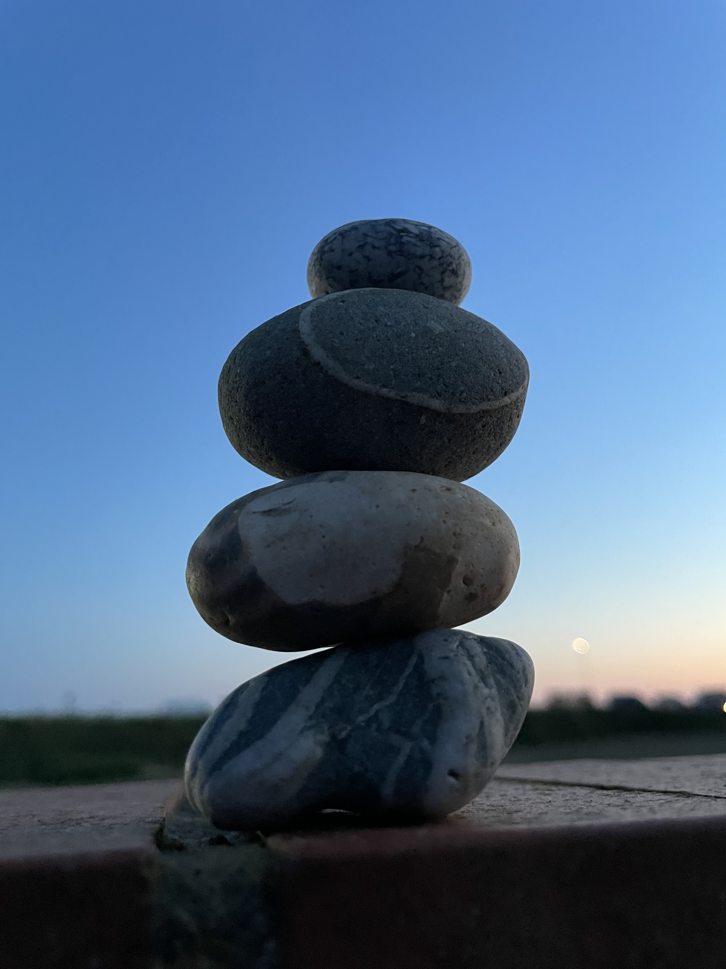 Balanced stacked stones at dusk
